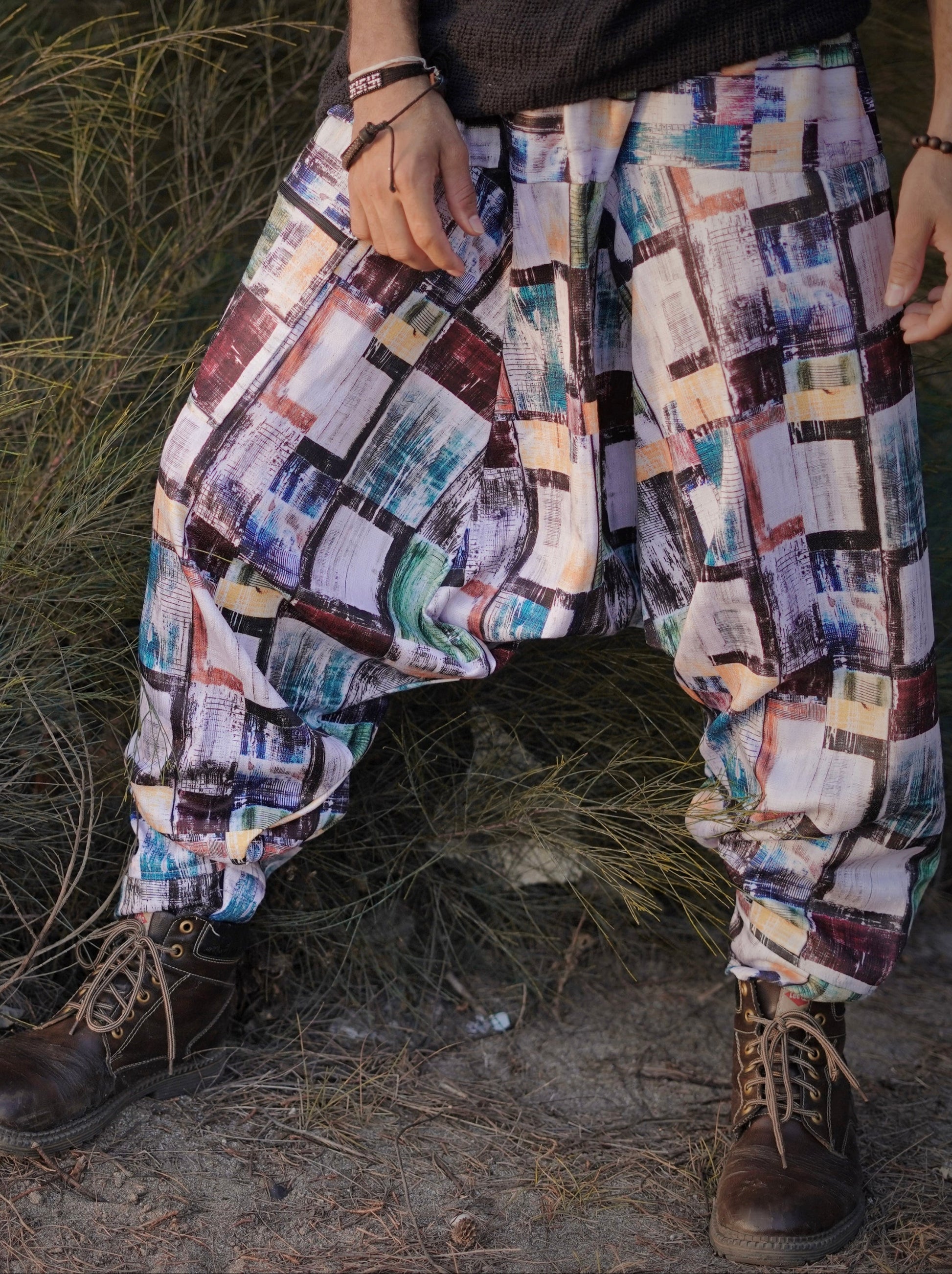 Multicolored patterned Harem pants worn by a person standing in a natural setting.
