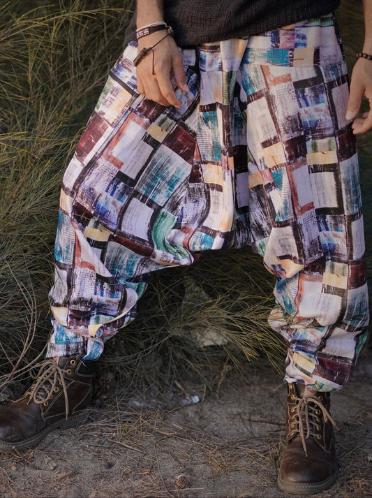 Multicolored patterned Harem pants worn by a person standing in a natural setting.