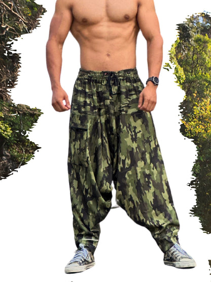 Man wearing camouflage harem pants with a forest background