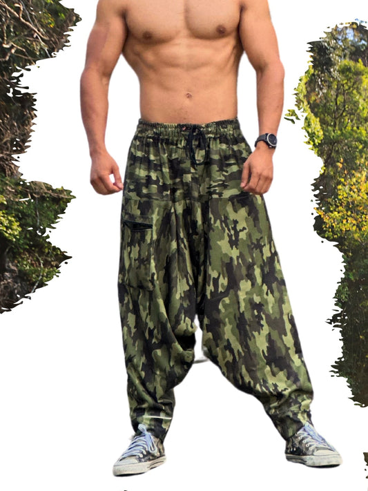Man wearing camouflage harem pants with a forest background