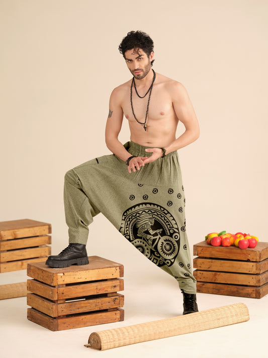 Men’s olive cotton harem pants with Warli tribal print, breathable fabric for yoga, travel and boho ethnic wear.