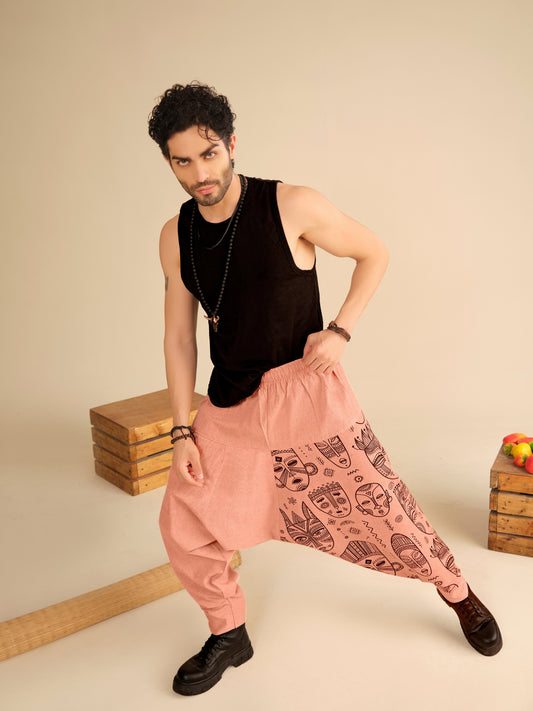 Men’s peach cotton harem pants with tribal mask print, breathable fabric for travel, casual and boho wear.